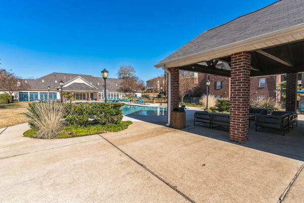 Covered poolside lounge and outdoor seating area at The Overlook student apartments Nacogdoches TX