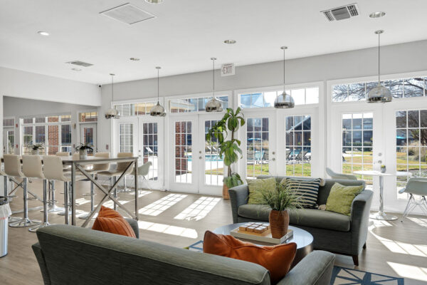 Bright clubhouse lounge with pool views and bar seating at The Overlook student apartments Nacogdoches