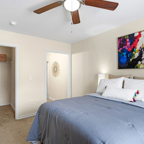 Furnished bedroom with walk-in closet in a student apartment at The Overlook Nacogdoches TX