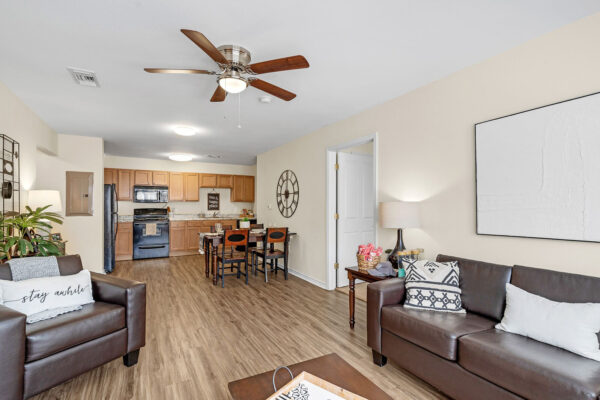 Open-plan furnished living room and kitchen in a student apartment at The Overlook Nacogdoches TX