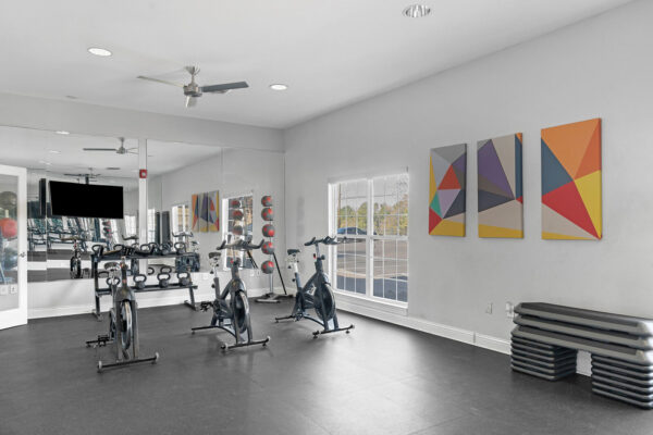 24-hour fitness center with spin bikes and free weights at The Overlook student apartments near SFA