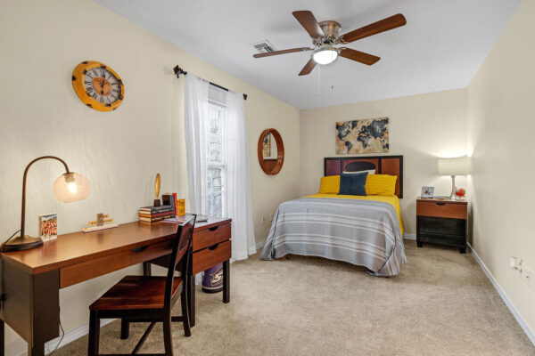Furnished bedroom with study desk in a student apartment at The Overlook Nacogdoches TX